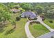 Stunning aerial view of a home featuring lush landscaping, a circular driveway, and a well-maintained lawn at 1661 Timber Hills Dr, Deland, FL 32724