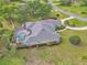 Aerial view showcasing the backyard oasis with screened in pool, mature landscaping, and privacy at 1661 Timber Hills Dr, Deland, FL 32724