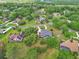 An aerial view of a suburban home surrounded by lush trees and verdant landscapes at 1661 Timber Hills Dr, Deland, FL 32724