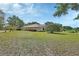 Large backyard with mature trees and landscaping at 1661 Timber Hills Dr, Deland, FL 32724