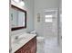 Stylish bathroom featuring a vanity with marble countertop, water closet and glass enclosed shower at 1661 Timber Hills Dr, Deland, FL 32724