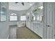 A luxurious primary bathroom boasts a soaking tub, a large mirror, and and sinks at 1661 Timber Hills Dr, Deland, FL 32724