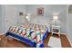 Cozy bedroom featuring hardwood floors, quilt bedspread and ambient lighting at 1661 Timber Hills Dr, Deland, FL 32724
