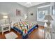 Cozy bedroom with quilt bedding, wood floors, and a bright sunny window at 1661 Timber Hills Dr, Deland, FL 32724