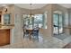 Cozy dining area with pool view, tile floors, and seating for four at 1661 Timber Hills Dr, Deland, FL 32724