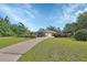 Desirable home with a side-entry two car garage, mature trees, and lush landscaping at 1661 Timber Hills Dr, Deland, FL 32724