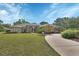 Stunning single-story home with meticulously landscaped front yard and curved driveway at 1661 Timber Hills Dr, Deland, FL 32724