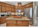 Well-equipped kitchen with custom wood cabinetry, stainless steel appliances, and center island at 1661 Timber Hills Dr, Deland, FL 32724