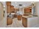Spacious kitchen featuring wood cabinets, granite countertops, stainless steel appliances and tile floors at 1661 Timber Hills Dr, Deland, FL 32724