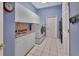 Well-organized laundry room with washer, dryer, sink, white cabinets, and blue walls at 1661 Timber Hills Dr, Deland, FL 32724