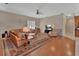 Inviting living room with hardwood floors, comfortable seating, and a large television at 1661 Timber Hills Dr, Deland, FL 32724