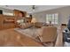 Cozy living room featuring hardwood floors, a large leather couch, and a custom built-in entertainment center at 1661 Timber Hills Dr, Deland, FL 32724
