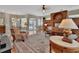 Spacious living room that overlooks the screened-in pool and outdoor dining area at 1661 Timber Hills Dr, Deland, FL 32724