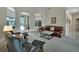 Bright living room with neutral carpet, leather furniture, and views of the pool at 1661 Timber Hills Dr, Deland, FL 32724