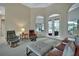 Another view of the sitting room with french doors leading to the lanai, high ceilings and comfortable seating at 1661 Timber Hills Dr, Deland, FL 32724