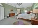 Bright primary bedroom with a ceiling fan, an en suite bathroom, and neutral decor at 1661 Timber Hills Dr, Deland, FL 32724