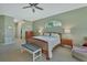 Comfortable primary bedroom with an en suite bathroom, a ceiling fan, and large windows at 1661 Timber Hills Dr, Deland, FL 32724