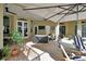 Covered patio with ceiling fans, brick flooring, and outdoor seating at 1661 Timber Hills Dr, Deland, FL 32724