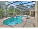 Screened in pool with brick patio, water feature, and landscaping at 1661 Timber Hills Dr, Deland, FL 32724