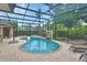Screened in pool with brick patio and waterfall feature at 1661 Timber Hills Dr, Deland, FL 32724