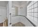 The elegant shower features marble walls, a glass block window, and a rainfall shower head at 1661 Timber Hills Dr, Deland, FL 32724