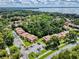 Aerial view of the community's lush greenery and the nearby lake at 168 Perimeter Ct # 5B, Deltona, FL 32725