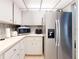 Well-lit kitchen with stainless steel refrigerator, white cabinetry and modern appliances at 168 Perimeter Ct # 5B, Deltona, FL 32725
