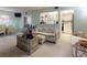 Inviting living room featuring comfortable seating, a view of the kitchen, and lots of natural light at 168 Perimeter Ct # 5B, Deltona, FL 32725