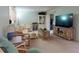 Spacious living room with stylish furnishings, a large TV and access to an outdoor patio at 168 Perimeter Ct # 5B, Deltona, FL 32725