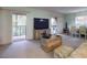 Comfortable living room featuring entertainment center, sliding door to balcony and adjacent dining area at 168 Perimeter Ct # 5B, Deltona, FL 32725