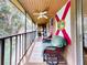Relaxing screened-in porch with wicker furniture, ceiling fan and a view of the lush surroundings at 168 Perimeter Ct # 5B, Deltona, FL 32725