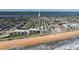 Aerial view of beachfront neighborhood with condos on the beach and homes lining the waterway at 18 Buckingham Dr, Ormond Beach, FL 32176