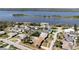 Aerial view of homes with swimming pools near a large waterway at 18 Buckingham Dr, Ormond Beach, FL 32176