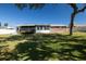 The backyard with screened patio, garden, and mature trees provides a serene outdoor space at 18 Buckingham Dr, Ormond Beach, FL 32176