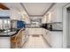 Galley kitchen with white cabinets, granite countertops, and stainless steel appliances at 18 Buckingham Dr, Ormond Beach, FL 32176