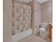 Bathroom showcases a tub with a seashell-themed curtain, along with a standard toilet at 1925 Hamilton Ave, Orange City, FL 32763