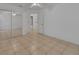 Tile flooring in a bedroom offering a clean, minimalist design with neutral colors and a ceiling fan at 1925 Hamilton Ave, Orange City, FL 32763