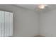 Simple bedroom with vertical blinds on the windows and a ceiling fan at 1925 Hamilton Ave, Orange City, FL 32763
