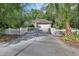 Charming single-story brick home with a well-manicured lawn and a white picket fence lined driveway at 1925 Hamilton Ave, Orange City, FL 32763