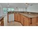 Spacious kitchen with wood cabinets, stainless steel sink, and ample counter space, ready for cooking at 1925 Hamilton Ave, Orange City, FL 32763