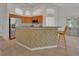 Bright kitchen features a breakfast bar with barstool seating and stainless steel appliances at 1925 Hamilton Ave, Orange City, FL 32763