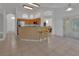 Bright kitchen with a breakfast bar, wood cabinetry, and an adjacent dining area with backyard access at 1925 Hamilton Ave, Orange City, FL 32763