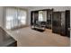 Spacious living room featuring neutral carpet and a stylish black display cabinet at 1925 Hamilton Ave, Orange City, FL 32763