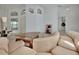 Bright living room featuring a sectional sofa and custom coffee table, with views to other living spaces at 1925 Hamilton Ave, Orange City, FL 32763