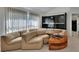 Spacious living room featuring a unique sectional sofa, modern shelving unit, and bright natural light at 1925 Hamilton Ave, Orange City, FL 32763