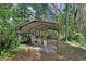 Exterior shot of a shed for storage among mature landscaping at 1925 Hamilton Ave, Orange City, FL 32763