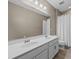 Modern bathroom featuring a double sink vanity, large mirror, and tiled floors at 199 Verde Way, Debary, FL 32713
