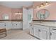 Well-lit primary bathroom featuring double vanities, granite counters, and wood-look tile at 199 Verde Way, Debary, FL 32713