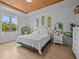 Bright bedroom with wood-look floors, leafy decor, and white furniture at 199 Verde Way, Debary, FL 32713
