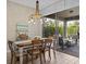 Casual dining area with rope chandelier, wood dining table, access to outdoor patio at 199 Verde Way, Debary, FL 32713